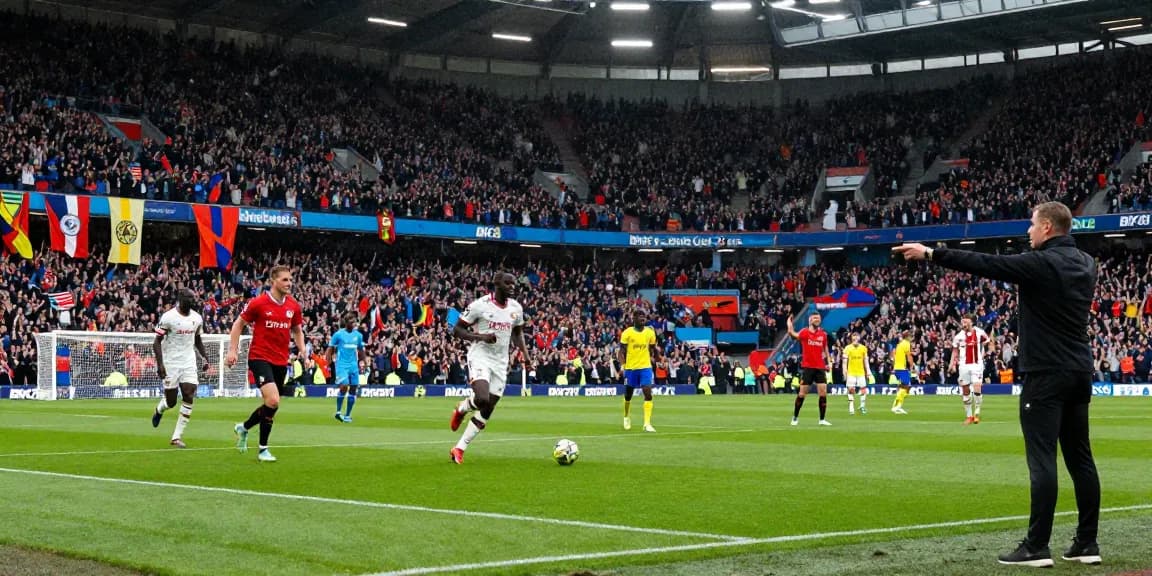 Exciting Premier League match with fans cheering and BK8 branding visible.